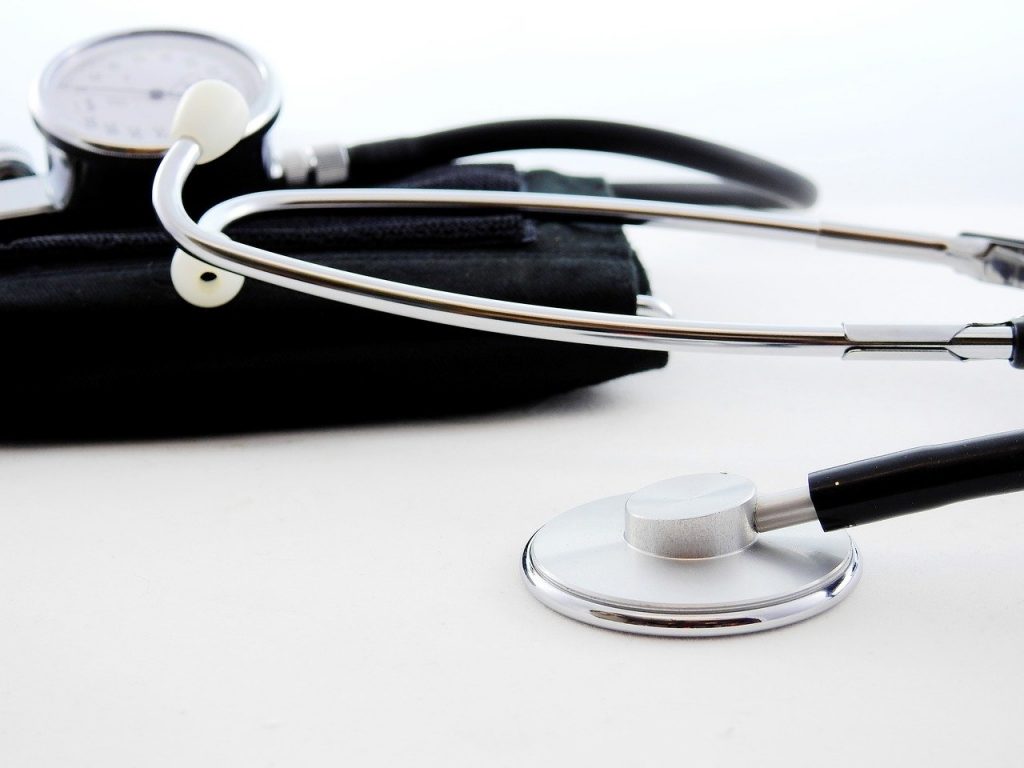 A silver and black doctors stethoscope lying on its side.