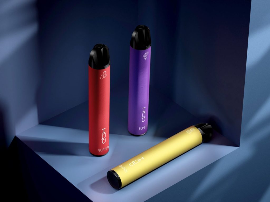 three HQD Super Pro disposable vape devices on a blue shelf